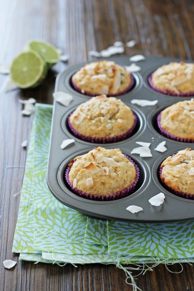 A muffin tin filled with Coconut Lime Muffins.