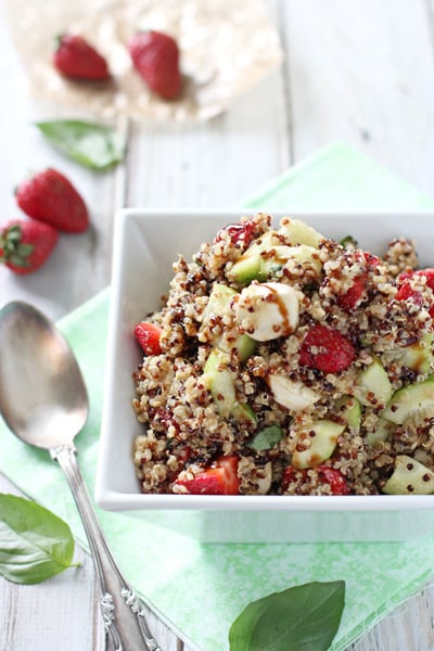 A white serving dish filled with Strawberry Quinoa Balsamic Salad.