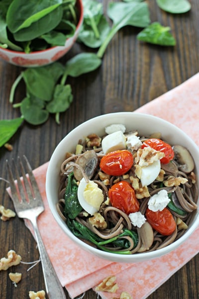 A white bowl filled with Soba Noodles with Roasted Tomatoes.