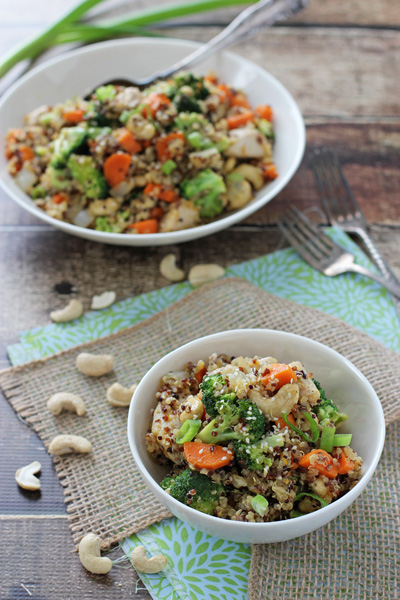 Two white dishes filled with Citrusy Quinoa Cashew Chicken and Broccoli.