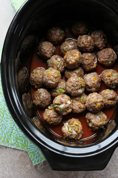 A crockpot filled with browned Tex-Mex Meatballs.