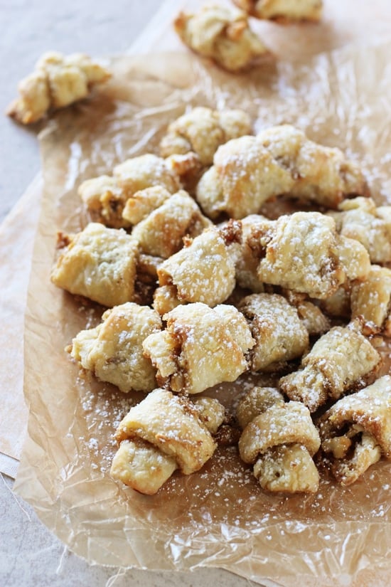 A pile of Butter Horns on a piece of crinkled parchment paper.