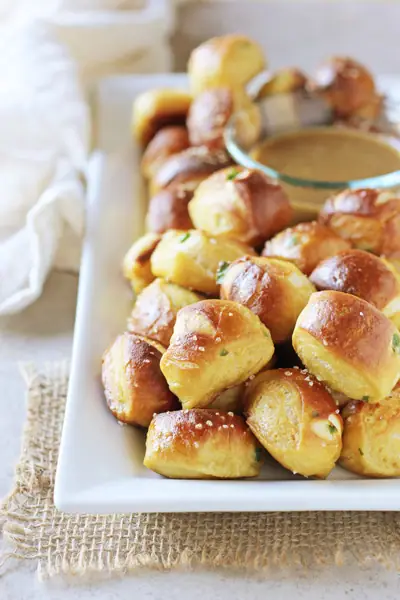 A white serving dish filled with Jalapeno Cheddar Soft Pretzel Bites.