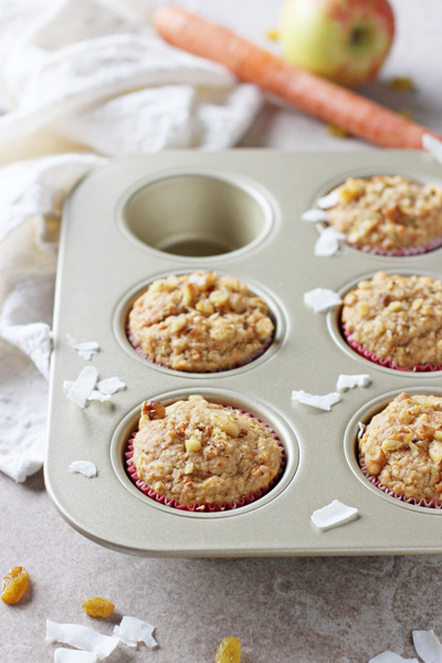 A muffin tin with several Whole Grain Morning Glory Muffins.