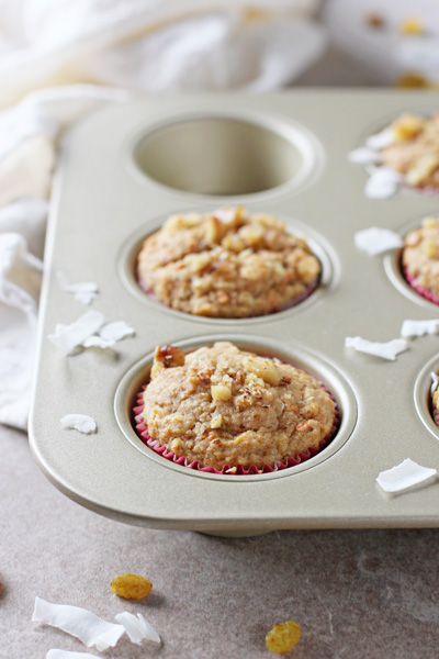 A muffin tin with several Whole Grain Morning Glory Muffins.