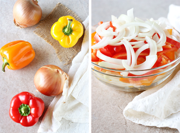 Fresh bell peppers and onions, and then them all sliced up in a bowl.