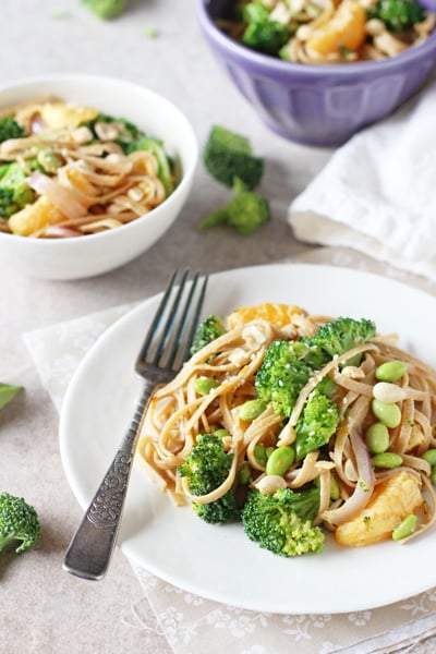 Three dishes filled with Orange Broccoli Noodle Bowls.