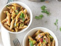 Recipe for sweet potato and black bean pasta skillet. With a creamy sauce made of sweet potato and packed with plenty of veggies and spices!