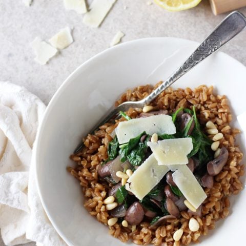 Recipe for nutty, chewy whole grain lemon garlic farro with mushrooms and spinach. Simple yet elegant.