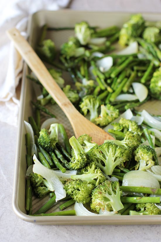 A tray of roasted broccoli, asparagus and onion.