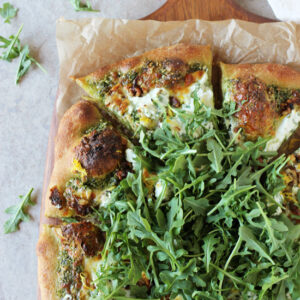 Recipe for arugula pesto pizza. With herbed ricotta, walnuts and lemon zest! Fresh, herby and cheesy!