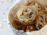 Recipe for blueberry almond whole grain muffins. With whole wheat flour, oat bran and sweetened with honey and maple syrup. Packed with blueberries!
