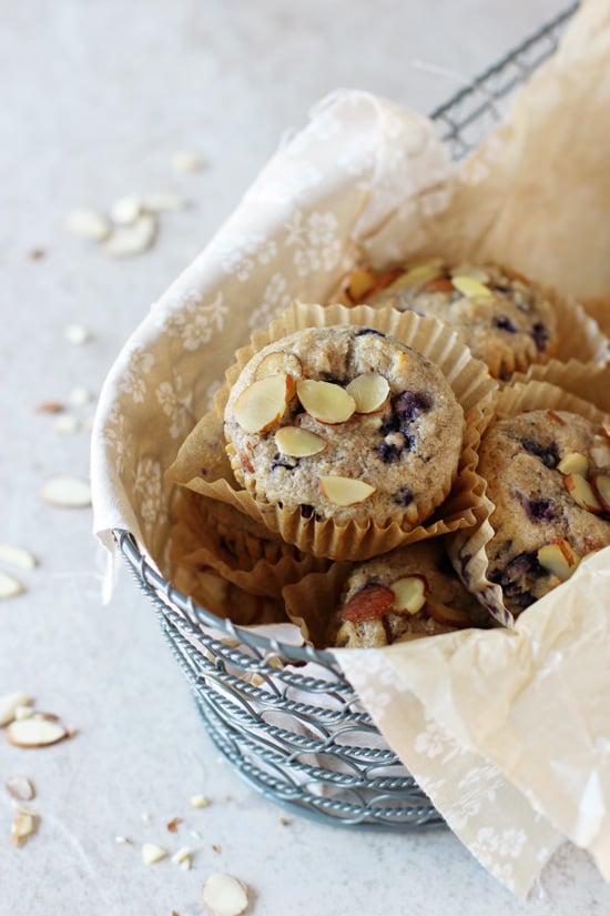 A bread basket filled with Blueberry Almond Muffins.