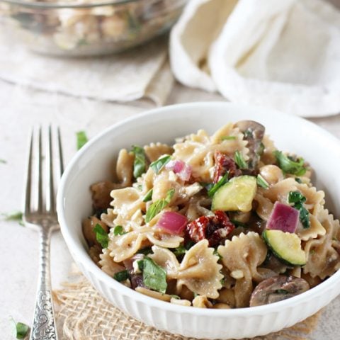 Recipe for mediterranean farfalle pasta salad. A light and flavorful dish that is delicious served hot or cold! Filled with veggies, herbs and a lemon mustard dressing.