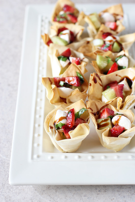 A white platter filled with Strawberry Mozzarella Phyllo Cups.