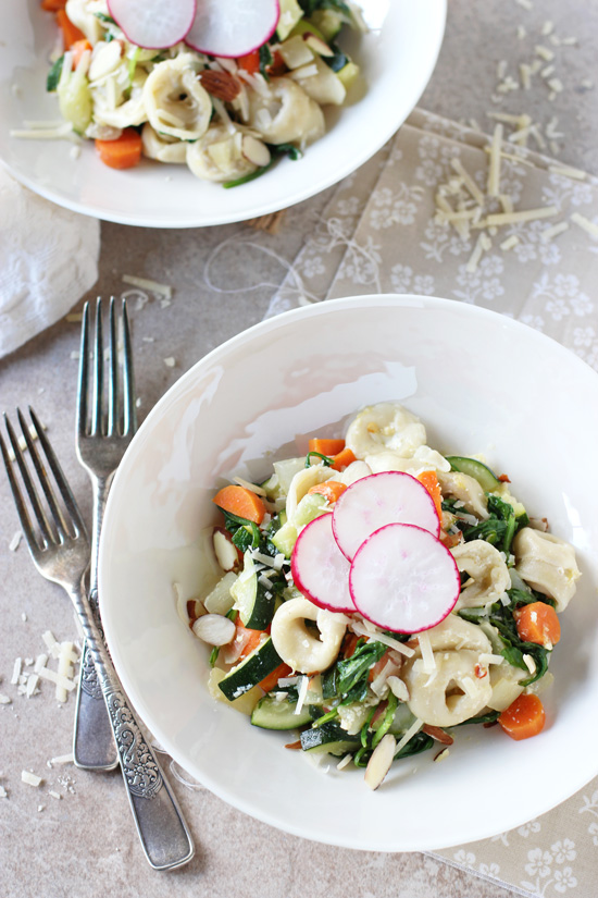 Two white bowls filled with Vegetable Tortellini Skillet.
