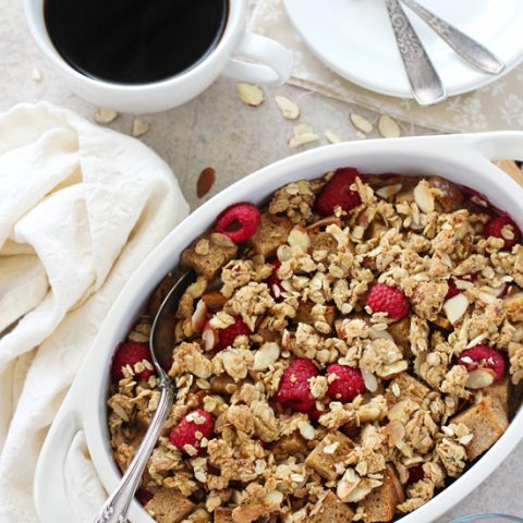 Recipe for overnight raspberry almond baked french toast. With whole wheat bread, fresh raspberries and an easy granola crumble topping!