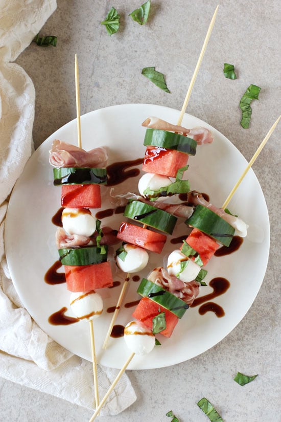 Three Watermelon Skewers on a white plate.