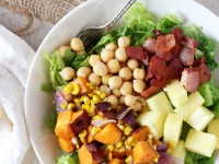 Recipe for sweet and salty BBQ sweet potato, chickpea and bacon salad. With roasted veggies, fresh pineapple, crispy bacon and a creamy BBQ sauce dressing!