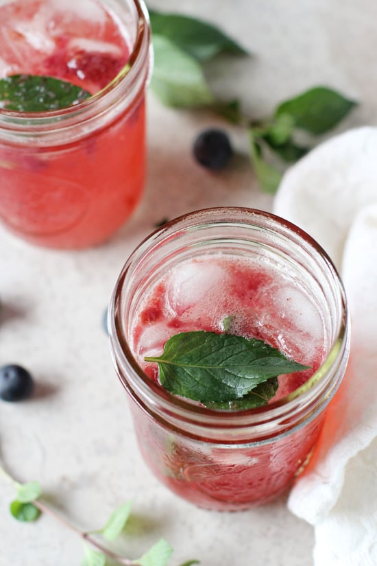 Two ball jars filled with Blueberry Mint Lemonade.