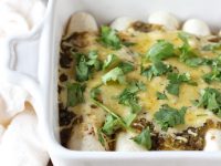 Recipe for fresh corn, zucchini and black bean enchiladas. With a creamy filling from a sauce made of fresh corn kernels! Topped with salsa verde and cheese!