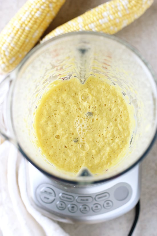 A blender filled with a sauce made with fresh corn.