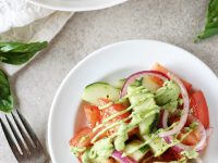 Recipe for quick and easy cucumber tomato salad. With fresh tomatoes, cucumbers and a creamy green goddess dressing lightened up with greek yogurt and avocado!