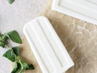 Recipe for creamy coconut mojito ice pops! Made with coconut milk, lime, maple syrup and vanilla bean! Vegan and dairy free!