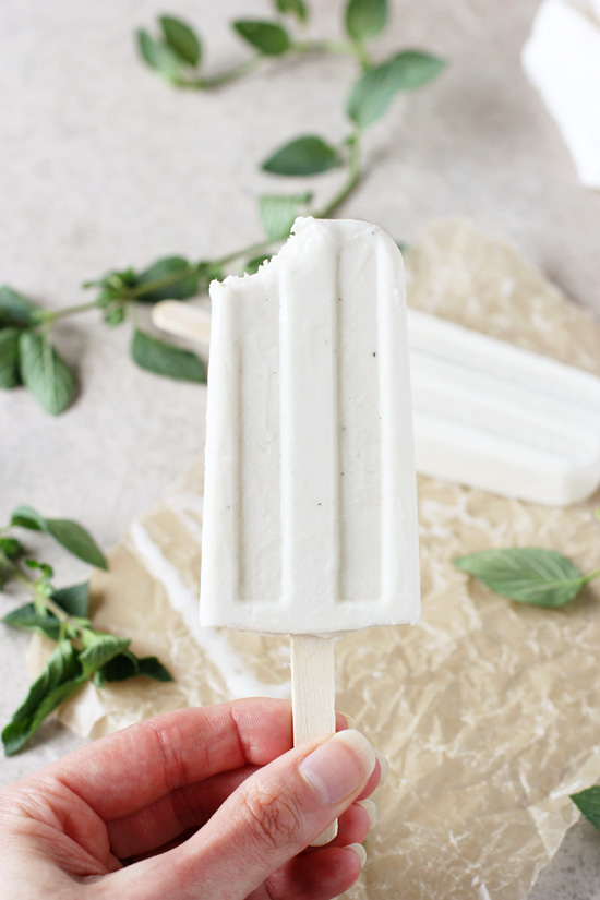 A Mojito Popsicle with a bite taken out.