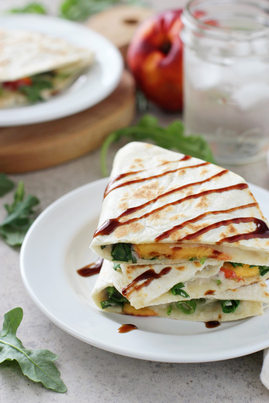 Several Peach Quesadillas stacked on a white plate.