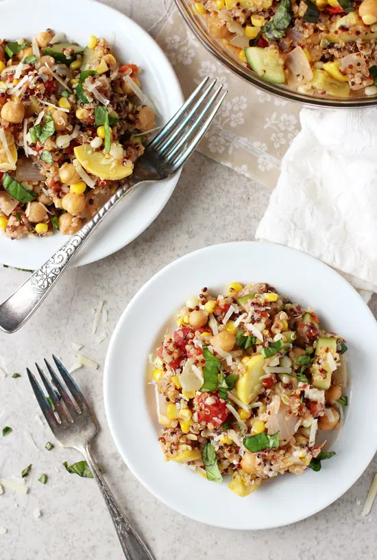 Two white plates filled with Summer Squash and Corn Quinoa.