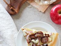 Recipe for sweet and savory apple bratwurst pizza. With sliced apples, sausage, red onion and goat cheese! An easy weeknight meal!