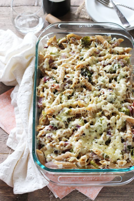 A glass baking dish filled with Brussels Sprout and Bacon Baked Pasta.