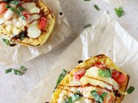 Recipe for caprese stuffed spaghetti squash. Spaghetti squash infused with basil and garlic, then filled with cherry tomatoes and mozzarella! Finished with balsamic glaze!