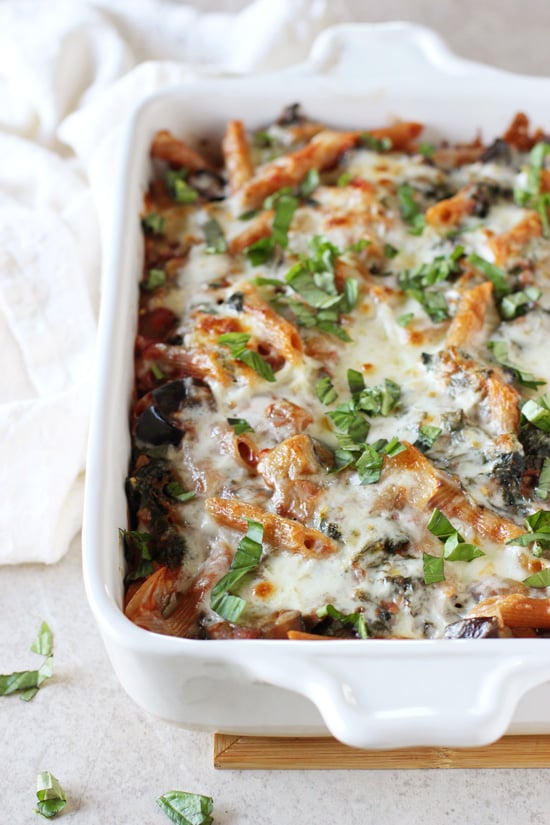 A white baking dish filled with Kale and Eggplant Baked Ziti.