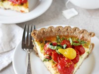 Recipe for tomato and goat cheese quiche. A simple, make ahead dish filled with green onions and goat cheese! And topped with plenty of roasted tomatoes!