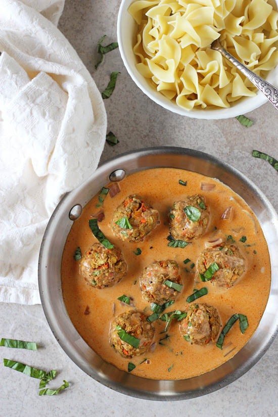 A stainless skillet filled with Thai Red Curry Baked Vegetable Meatballs.