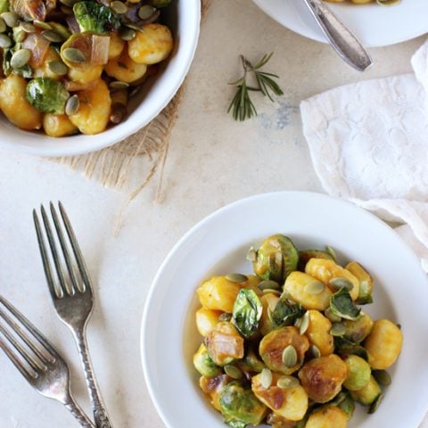 Recipe for pumpkin and brussels sprout gnocchi. With a creamy pumpkin sauce & pan-roasted sprouts! Have this cozy meal on the table in 35 minutes or less!