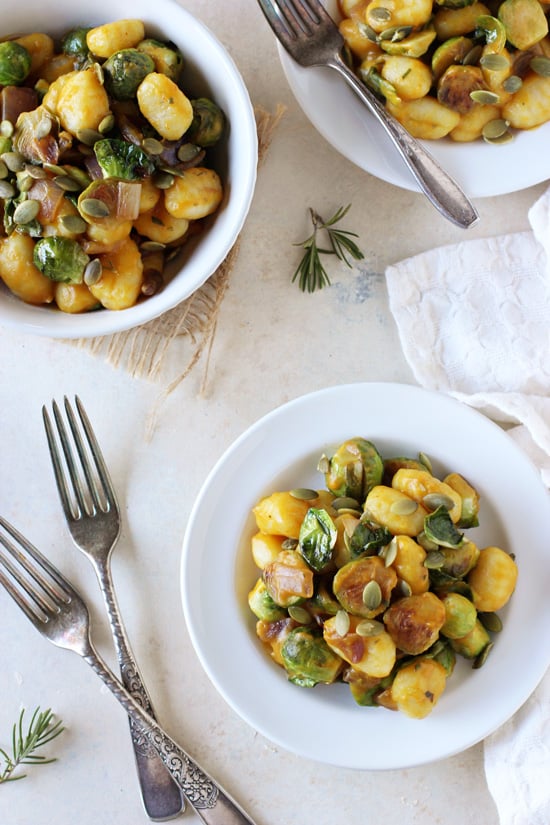 Three white dishes filled with Pumpkin and Brussels Sprout Gnocchi.