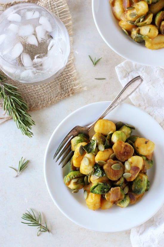 Two white plates filled with Creamy Pumpkin Gnocchi.