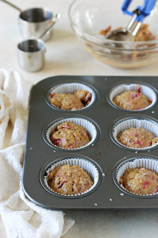 A muffin tin filled with batter for Cranberry Sauce Muffins.