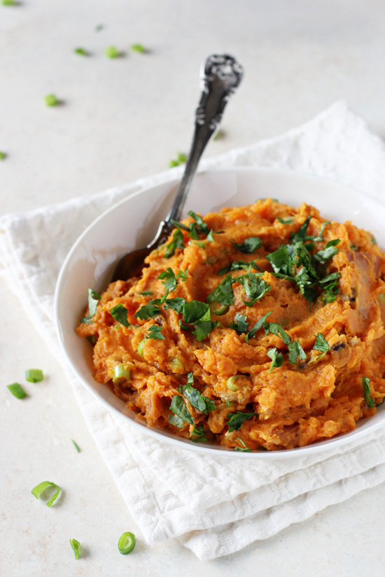 A white bowl filled with Easy Mashed Sweet Potatoes.