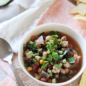 Recipe for easy slow cooker vegetarian tortilla soup! Filled with veggies, beans and plenty of spices! Serve with lots of fun toppings!