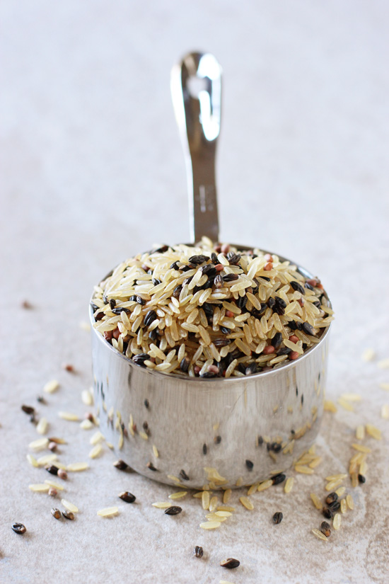 A measuring cup filled with dry wild rice.