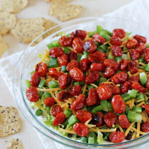 A lighter yet jam-packed with flavor healthier layered taco dip recipe. Colorful, fresh and a crowd-pleasing favorite!