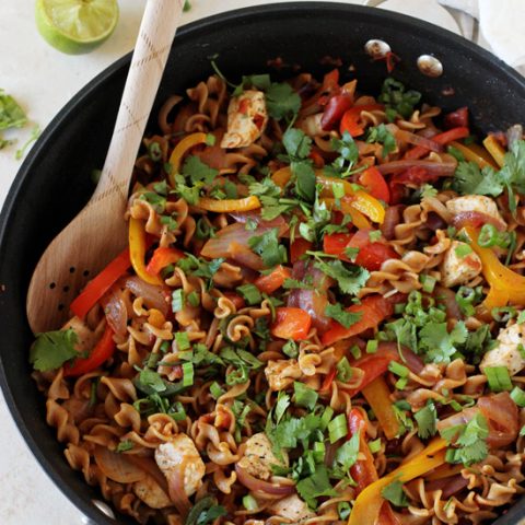 Recipe for skillet chicken fajita whole wheat pasta. Everything cooks in just one skillet! Even the pasta! Healthy and packed with veggies!