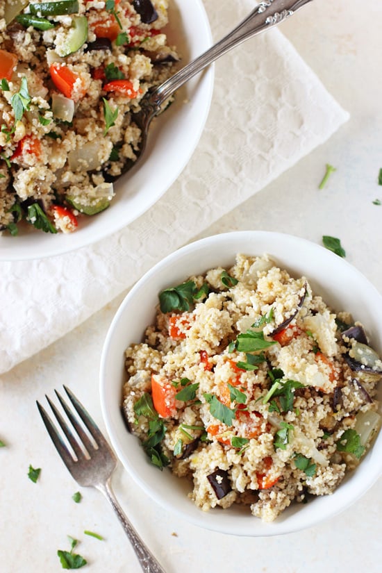 Two white bowls filled with Greek Couscous Salad.