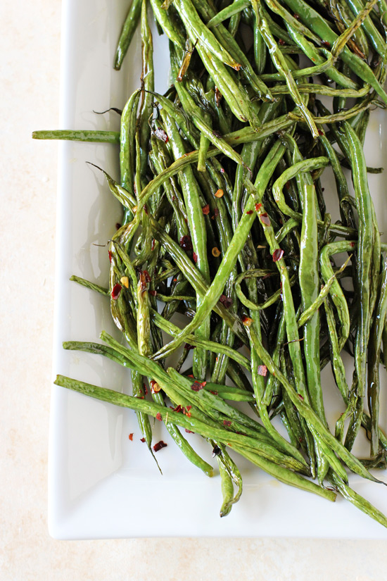 A white serving platter filled with Sweet and Spicy Green Beans.