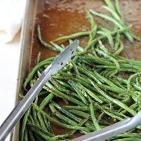A delicious, healthy and crazy easy recipe for sweet and spicy green beans! French green beans roasted with sweet honey and spicy red pepper flakes!
