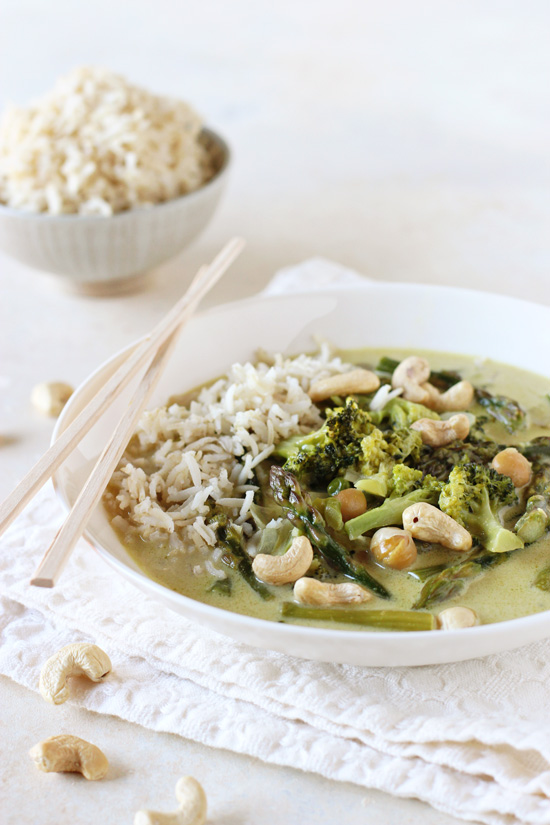 A white bowl filled with Vegan Thai Green Curry with brown rice in the bowl.